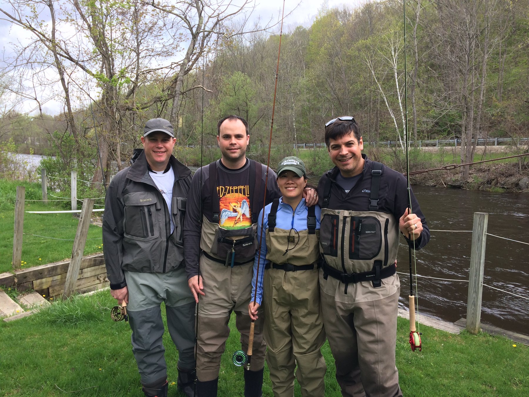 Fly fishing group standing beside a river after a guided trip